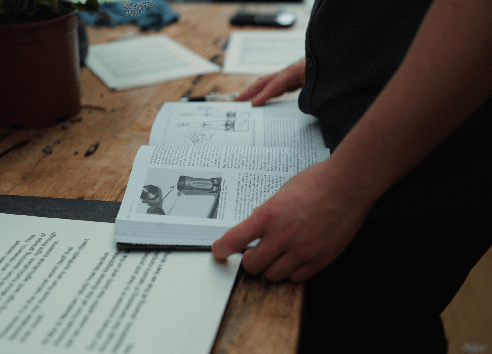 Reading a plant-science reference in the studio